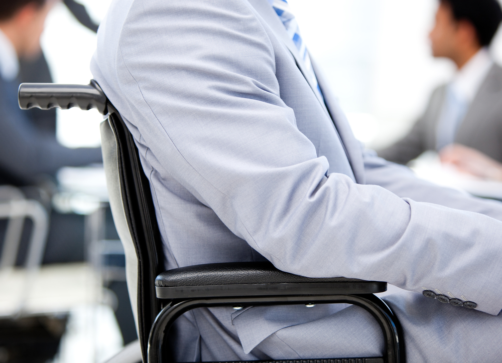 Close-up of a businessman sitting on a wheelchair in a meeting